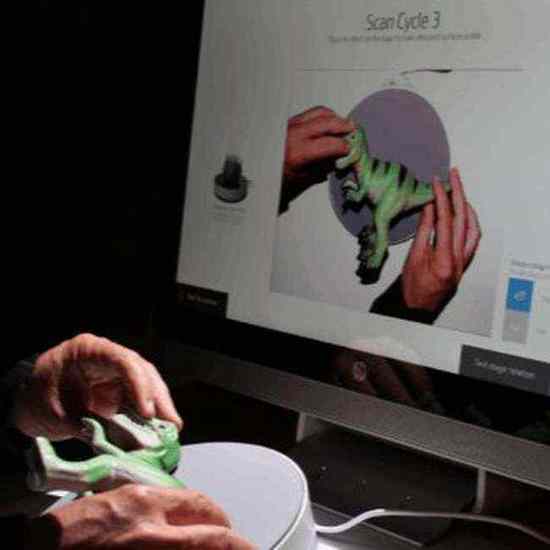 Close-up — hands repositioning dinosaur on stage following pie chart guidance